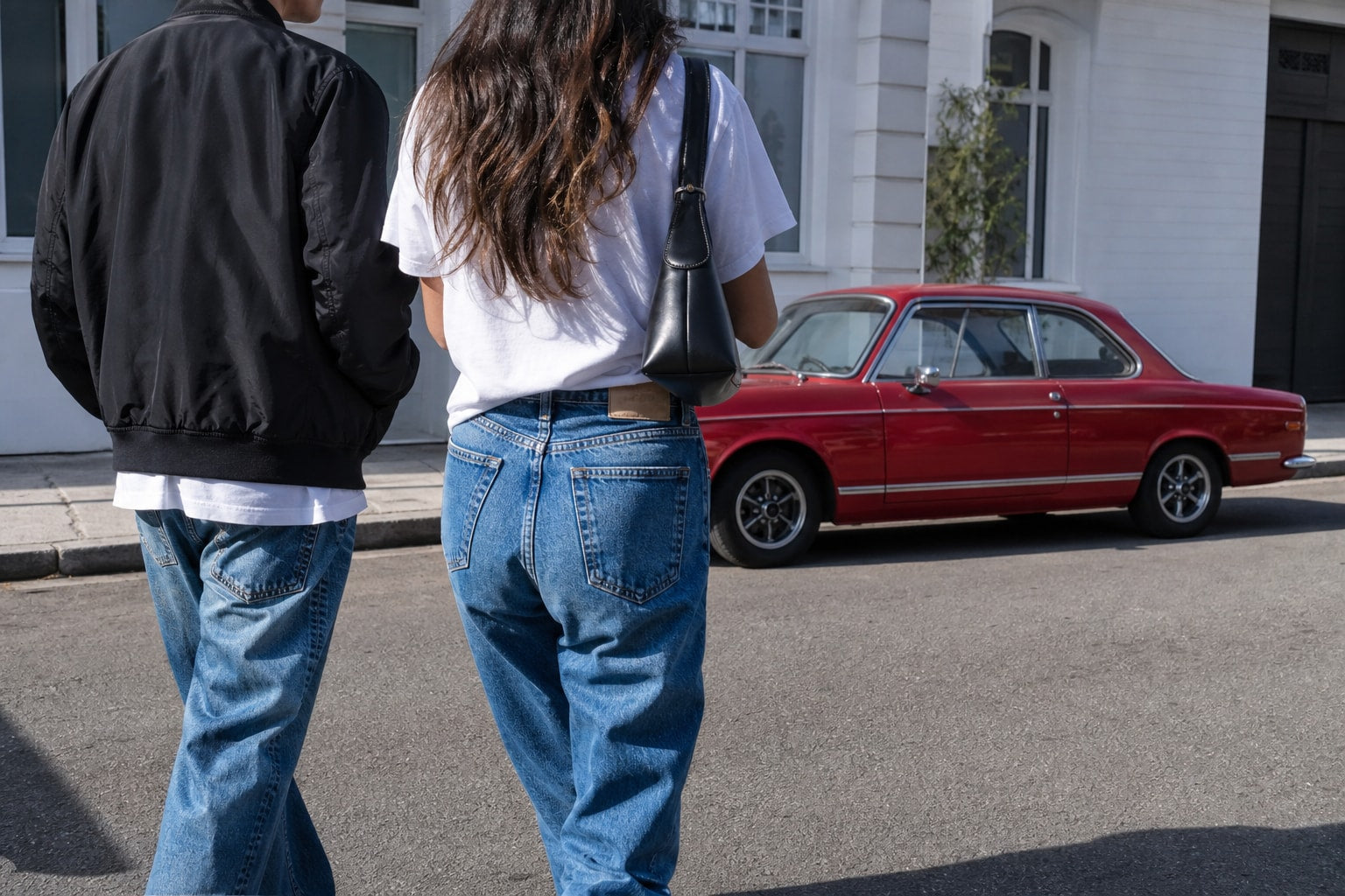 Friends heading out together on a sunny city street